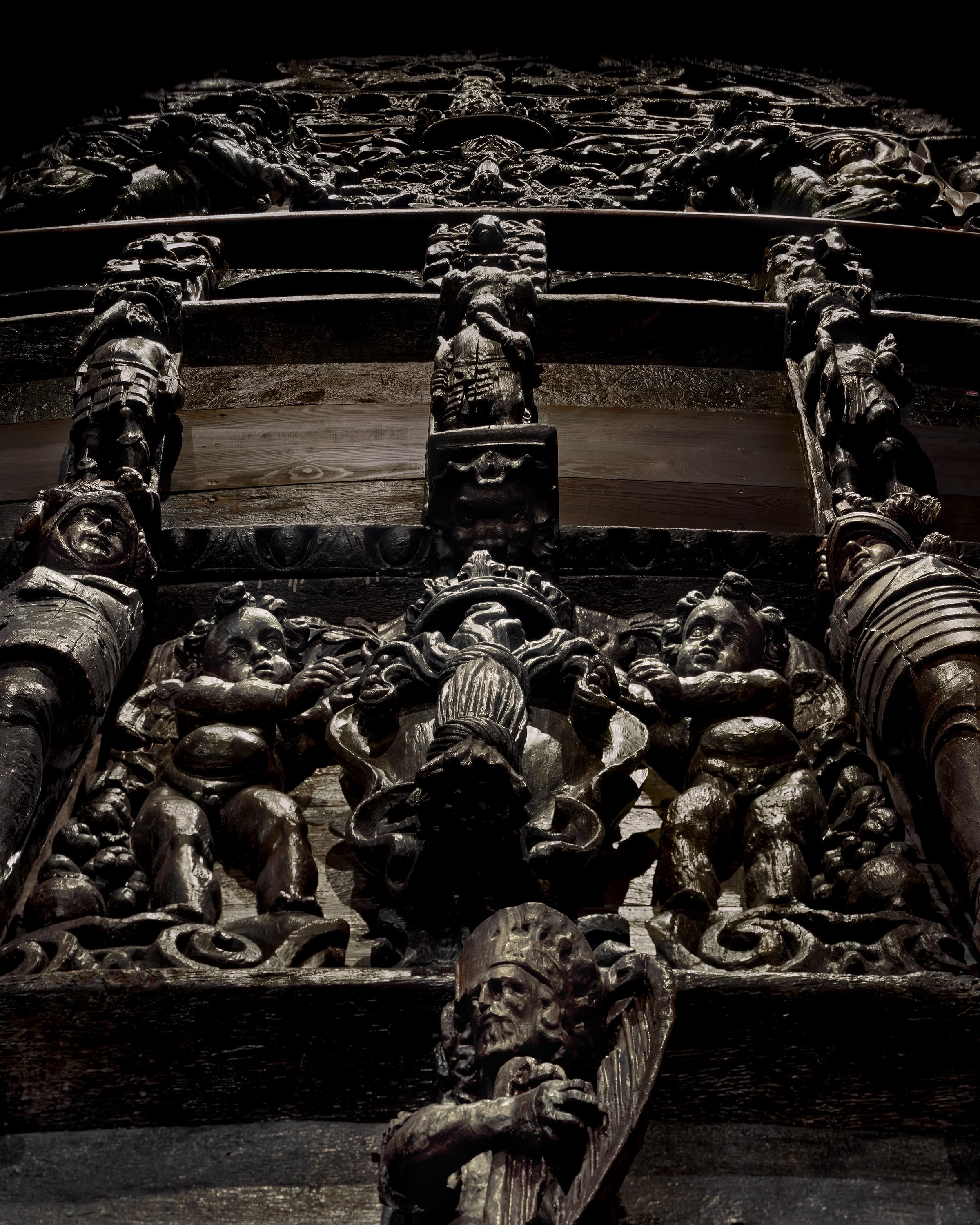 A view up the ornately carved stern of the Vasa, carvings of religious figures and soldiers.