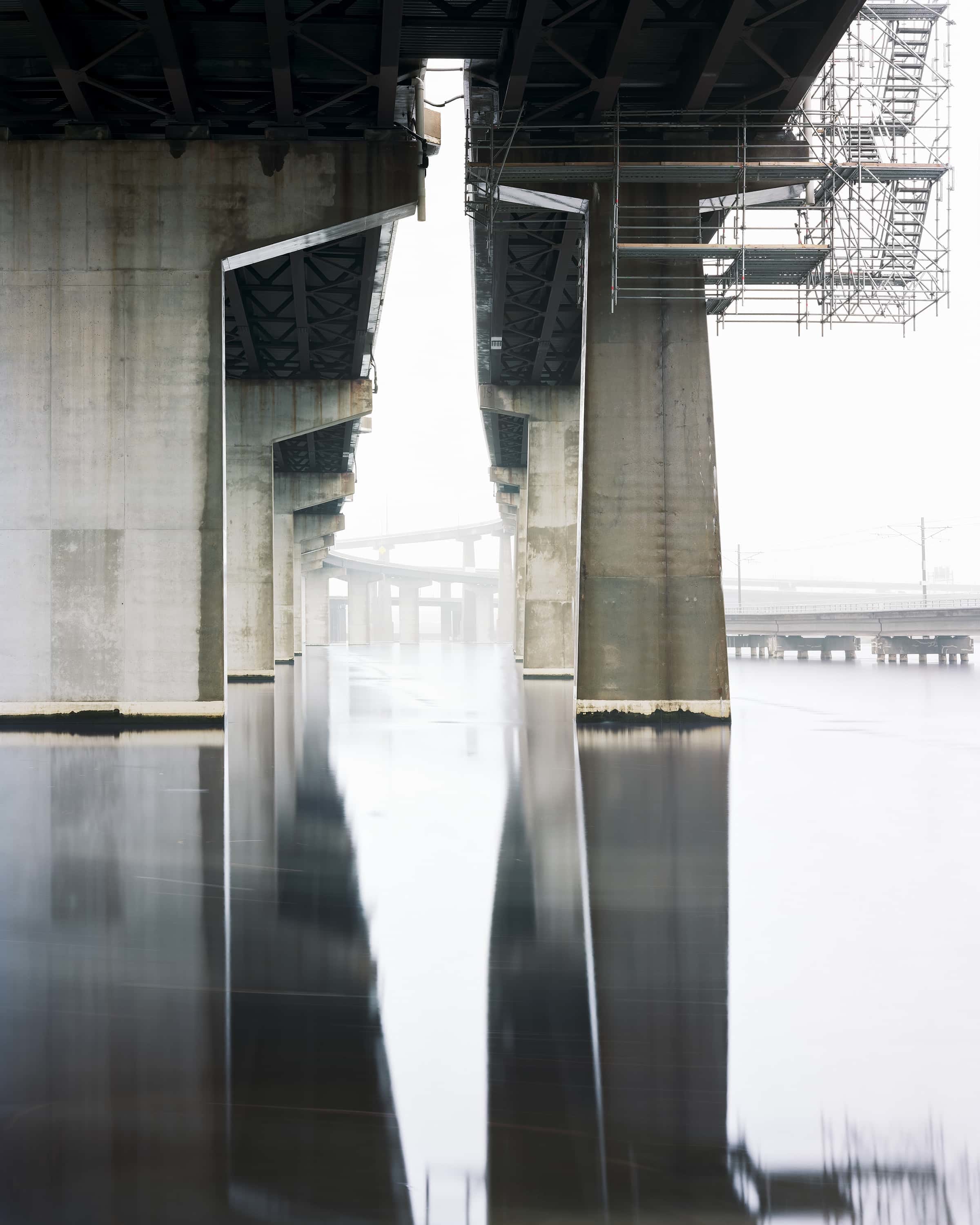 Under the raised section of interstate 395 (with construction on the right pier) as it passes over at Baltimore harbor in the midst.