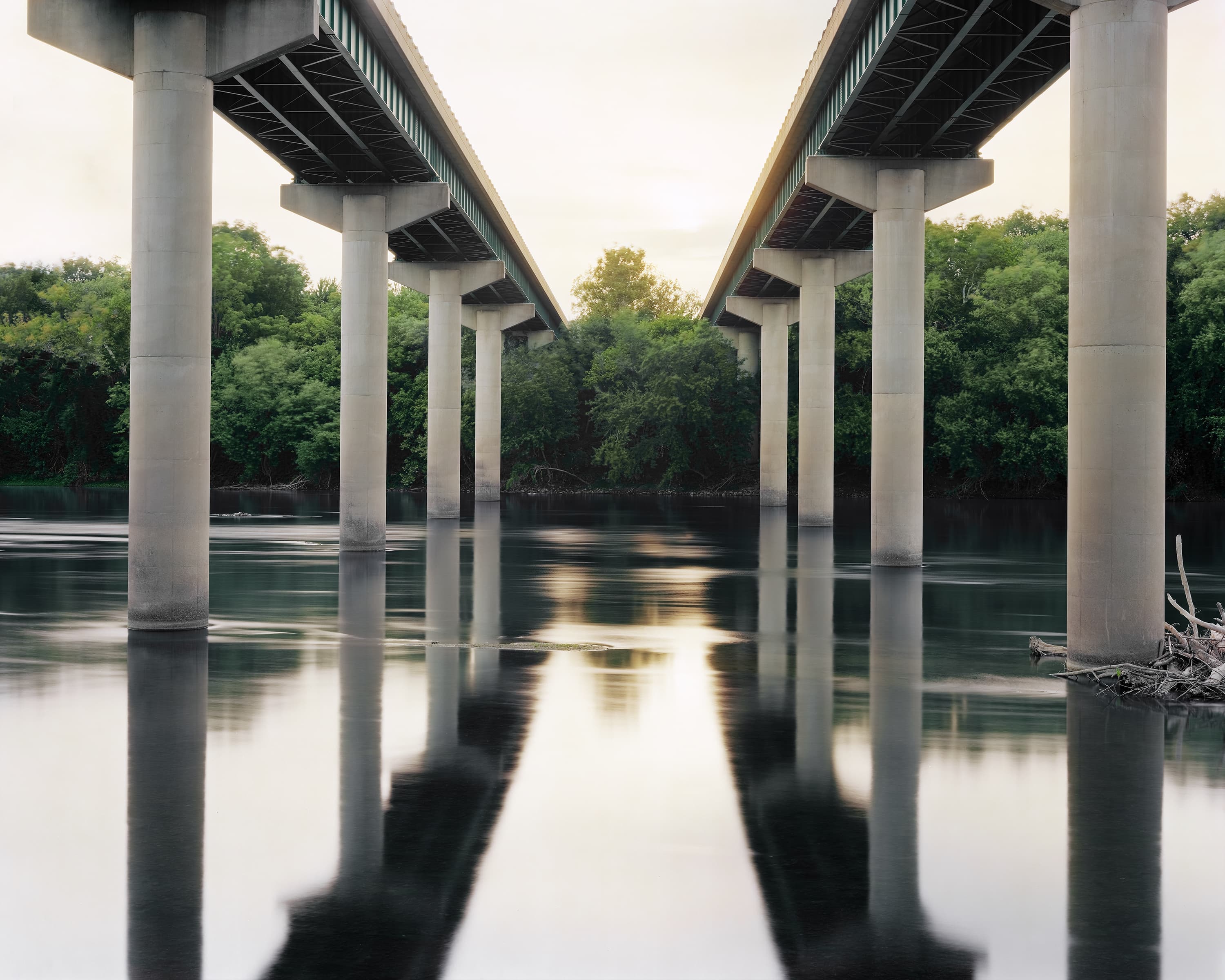 Two bridges, mirroring each other crossing the Potomac river at sunset.