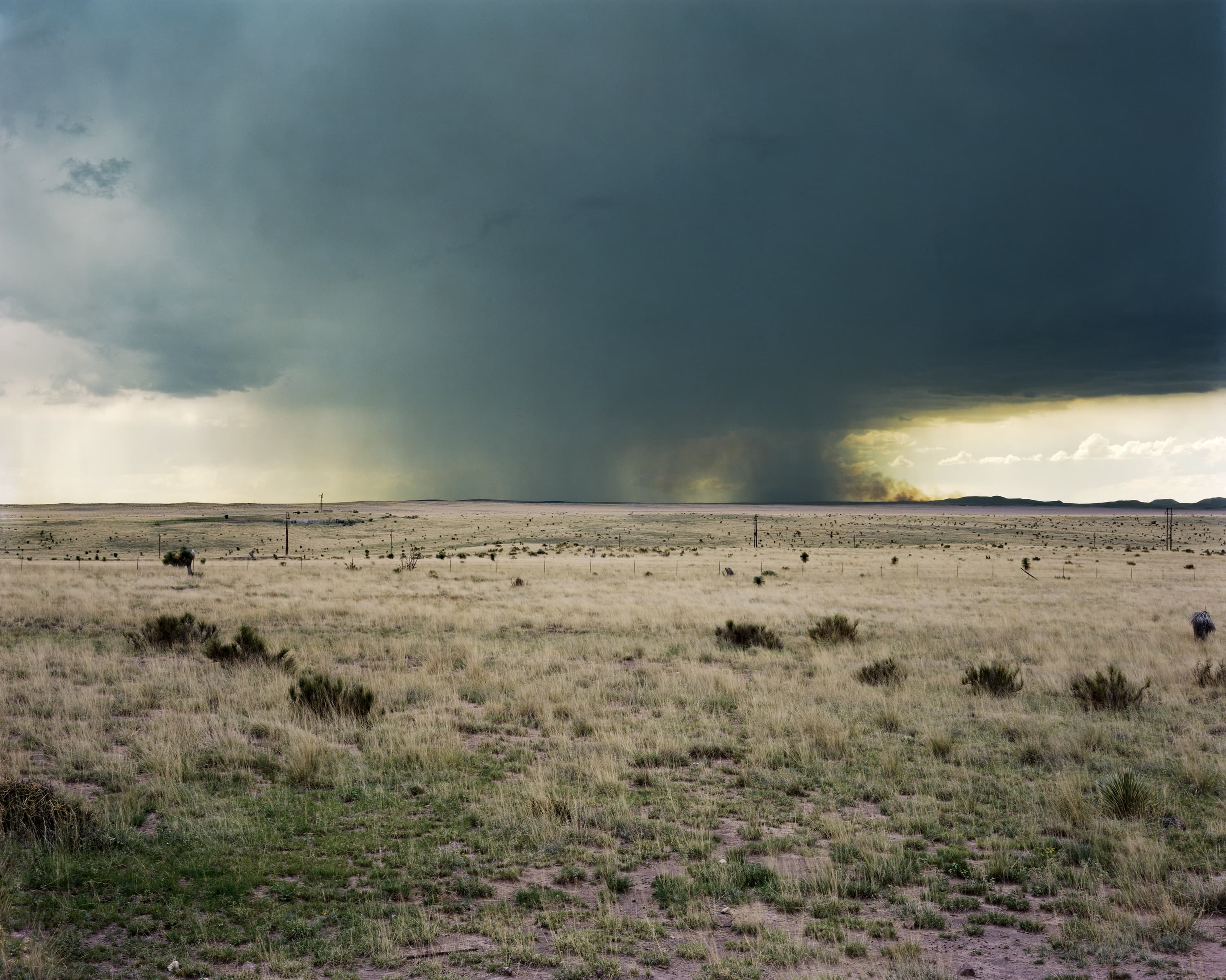 Lighting storm in Marfa, Texas. On the horizon on the right is the smoke from a brushfire that was ignited by the lightning.