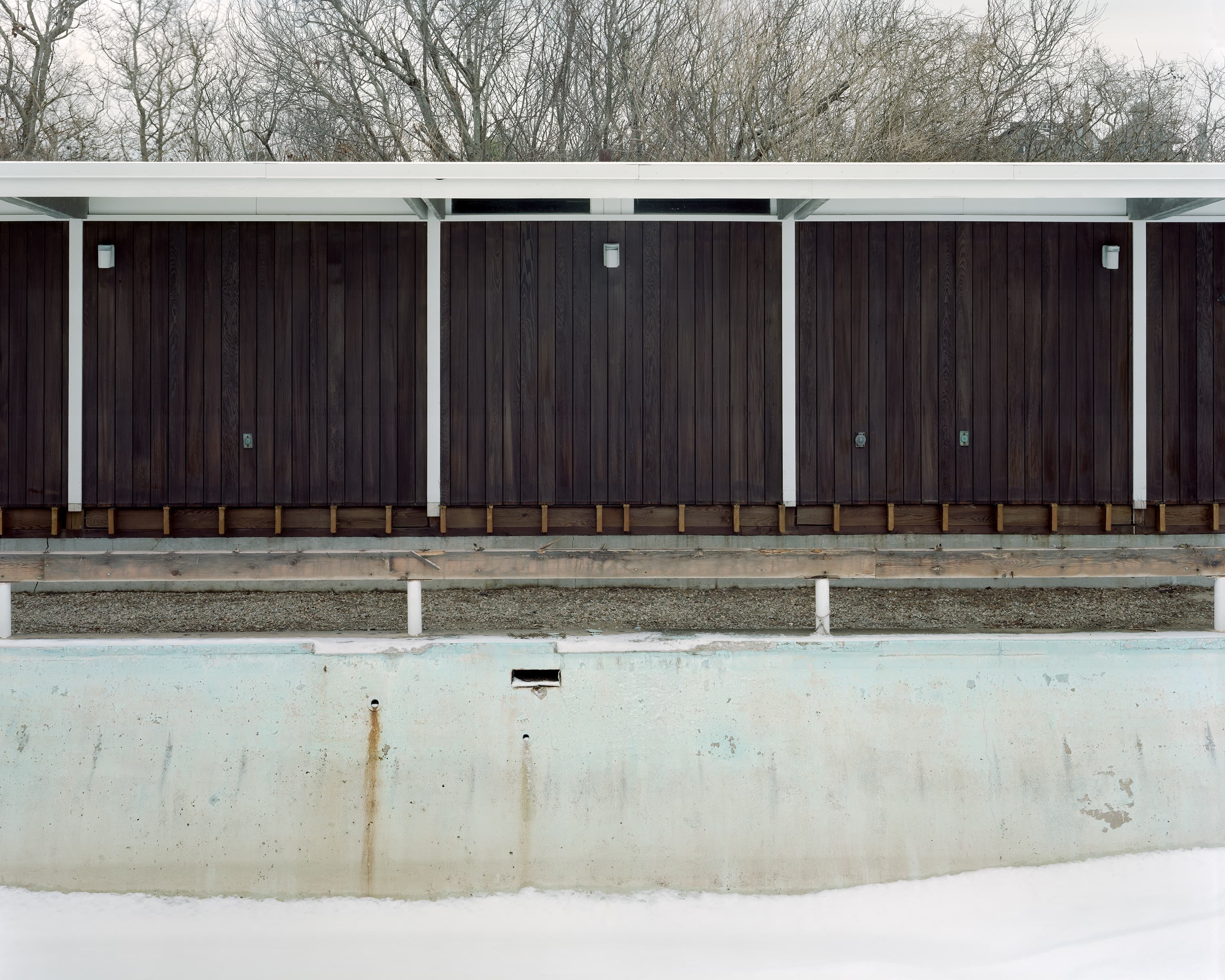 Outdoor swimming pool filled with snow.