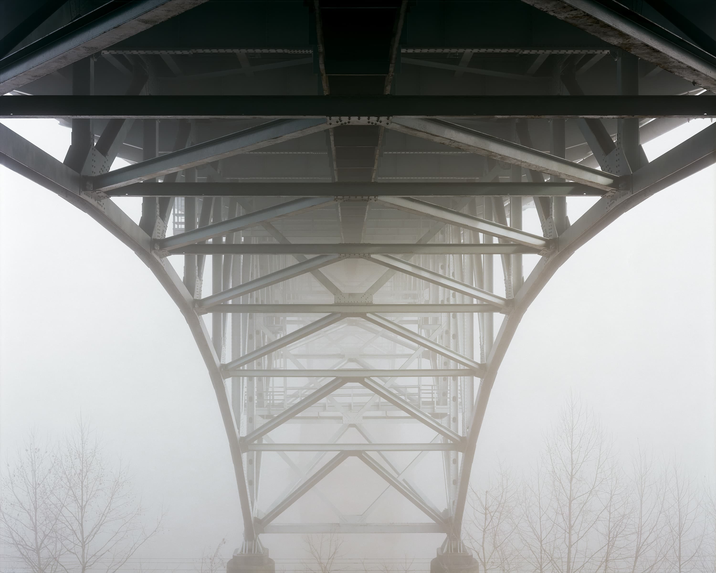 Under the deck truss bridge over Allegheny River, covered in fog.