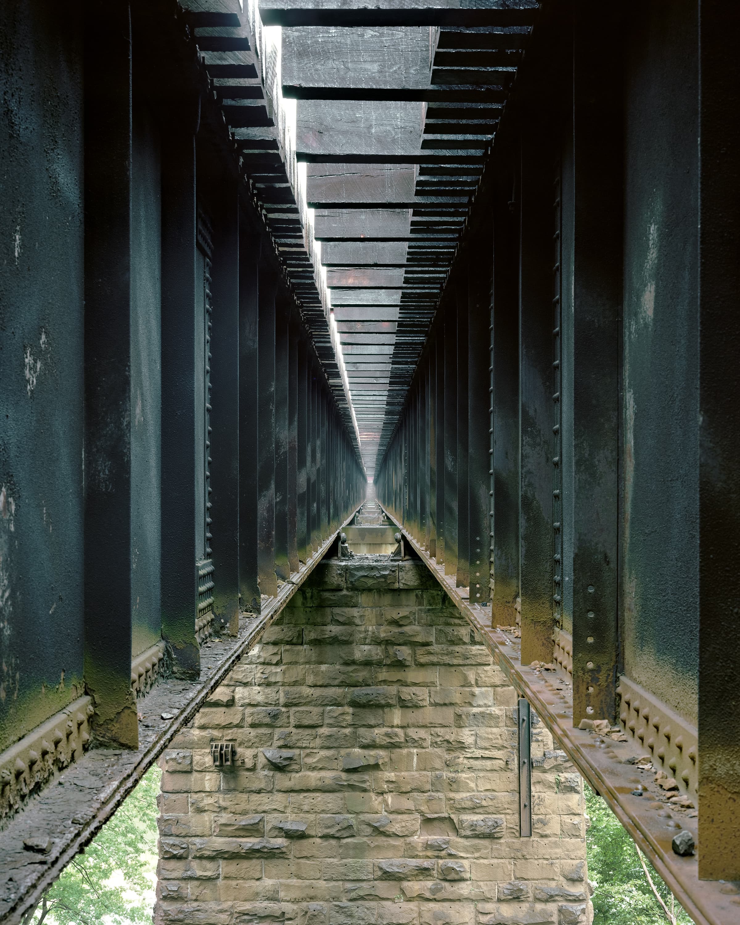 On top of the interior piers of the deck plate girder bridge.