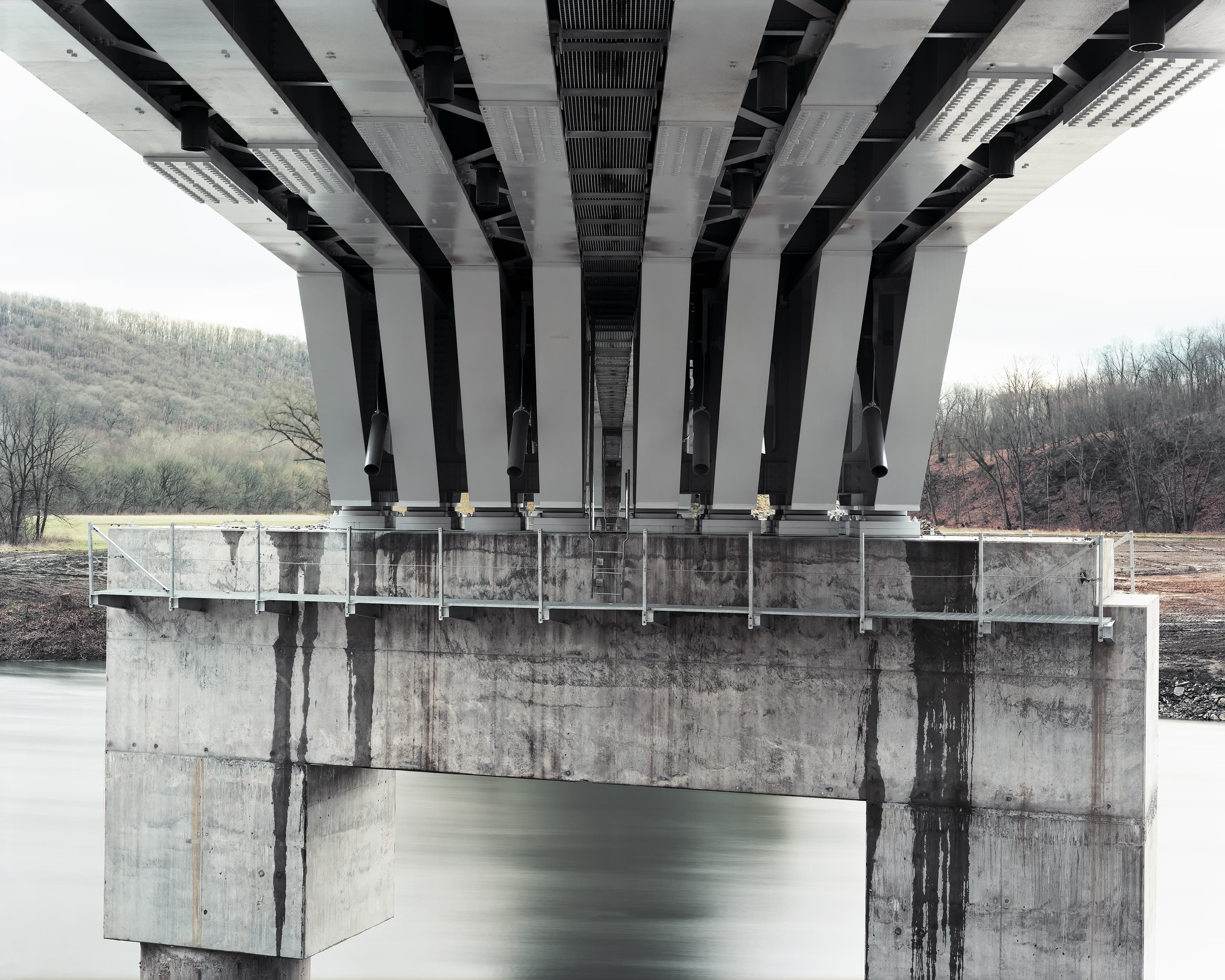 Concrete pier and steel substructure of a modern railway bridge.