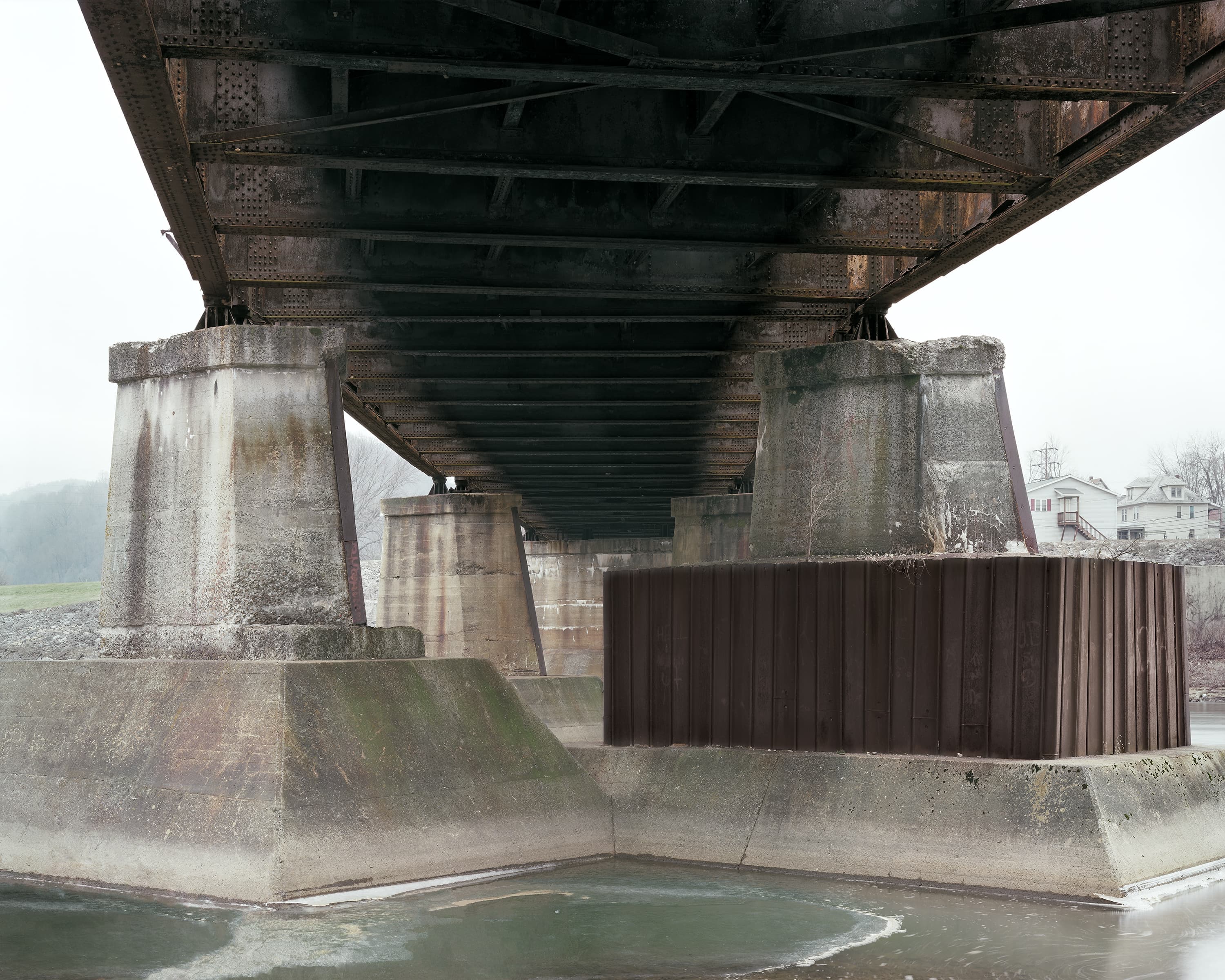 Heavily reinforced piers of pony/through plate girder bridge.